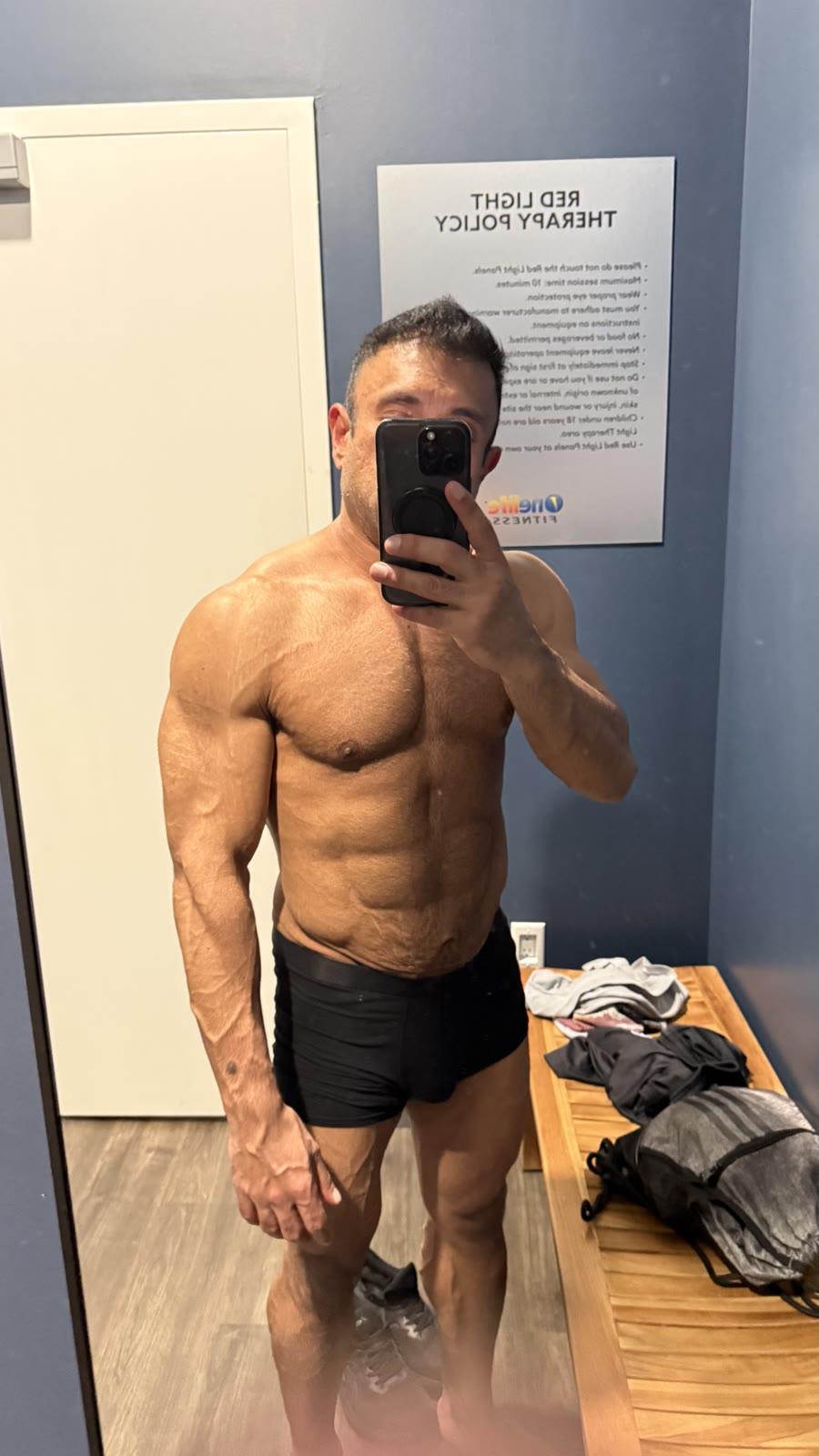 Hammad in August 2026, angled gym mirror selfie showing a lean, muscular build